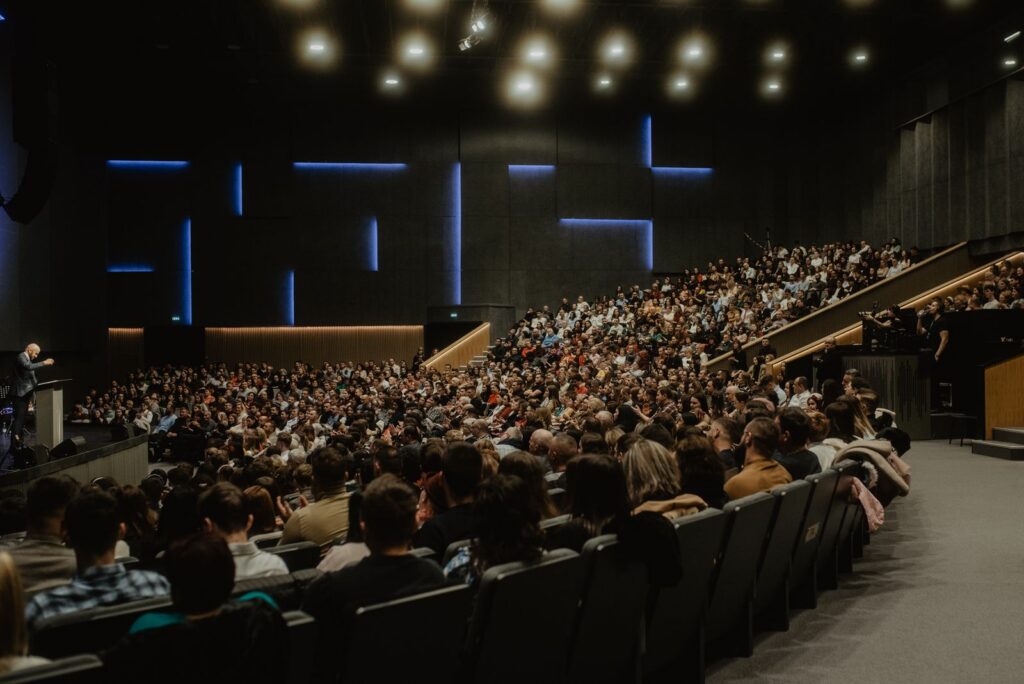 Speaker presenting on stage at a professional conference